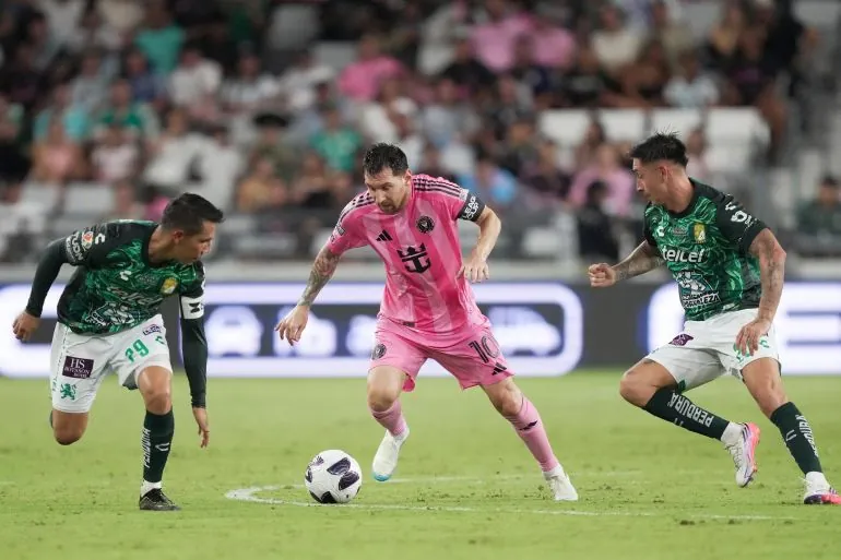 Inter Miami’s Leo Messi, centre, is pressed by León’s Jose Alvarad, left, and James Rodriguez, right, during the Leagues Cup match